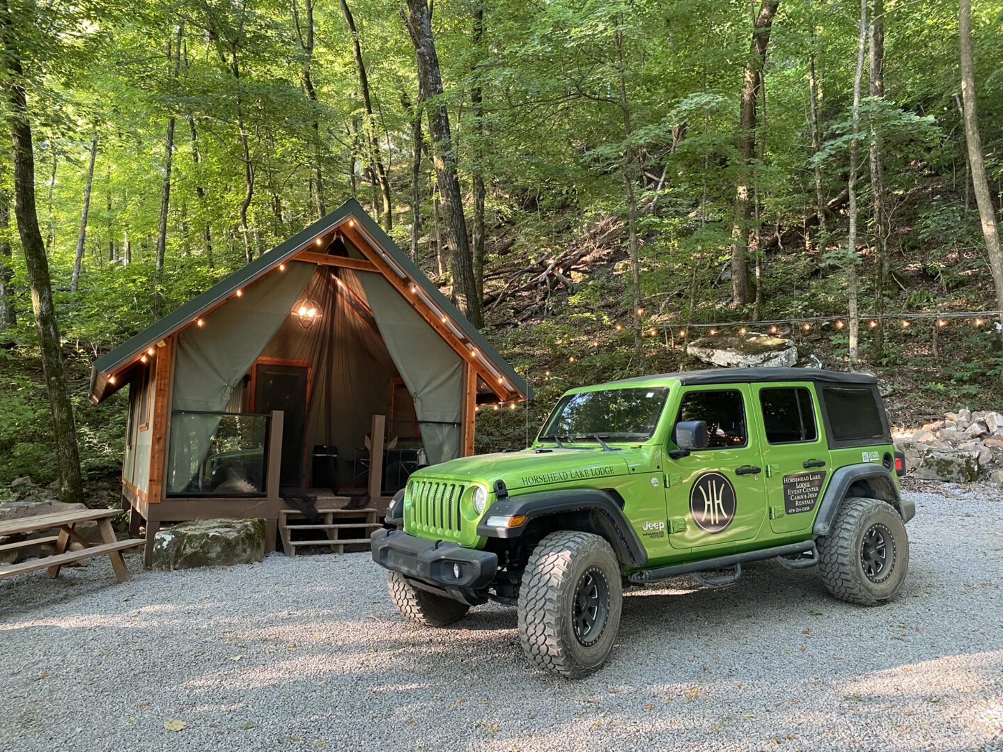 A jeep parked in front of a tent.