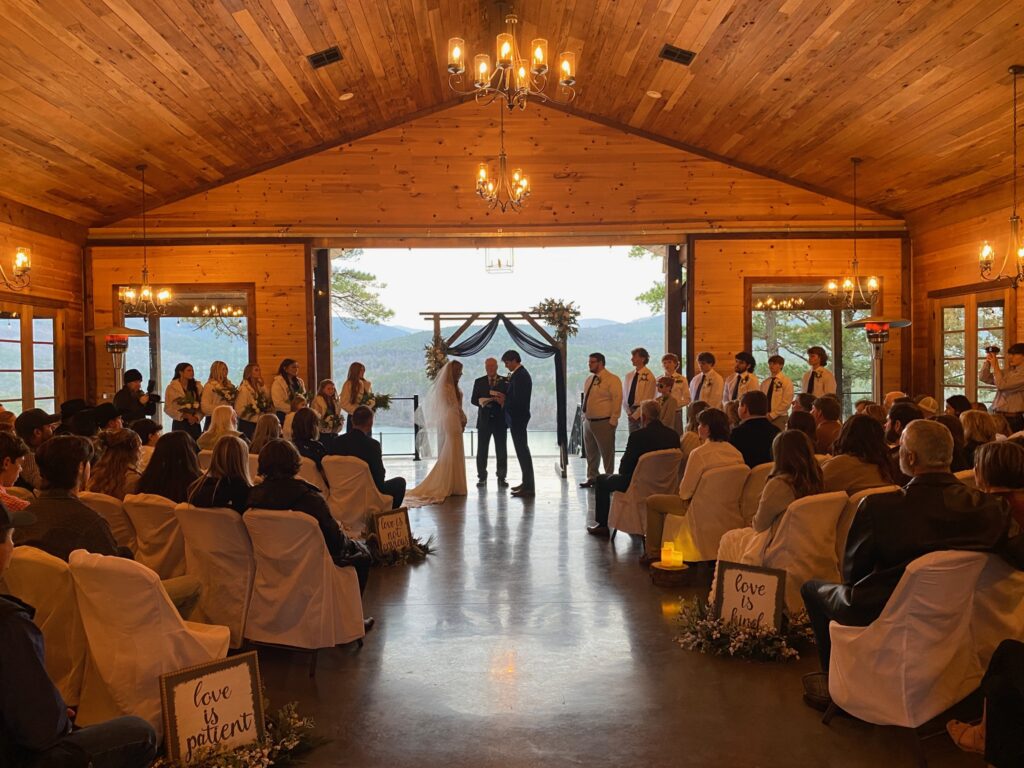 A wedding ceremony in the middle of an indoor venue.
