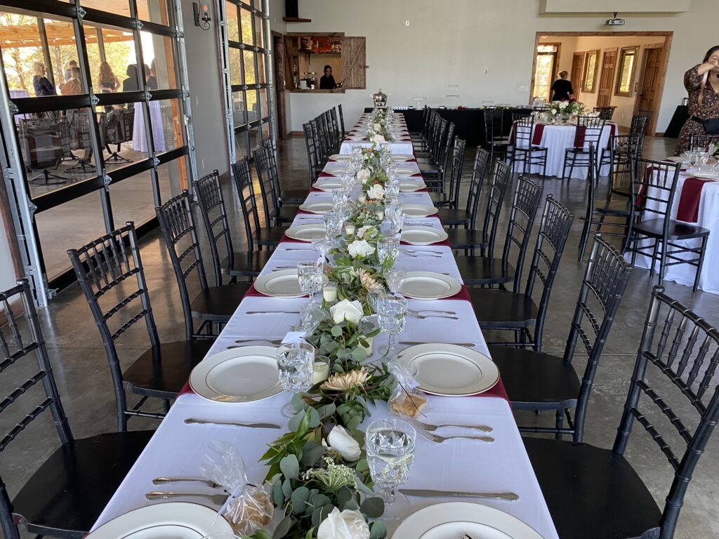 A long table with plates and silverware on it