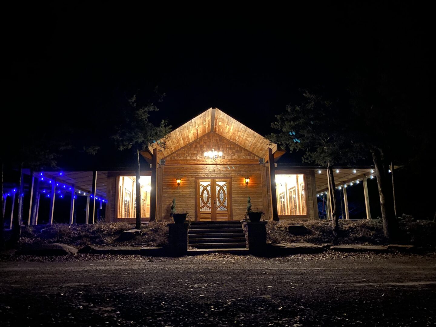 A wooden house with lights on the outside.