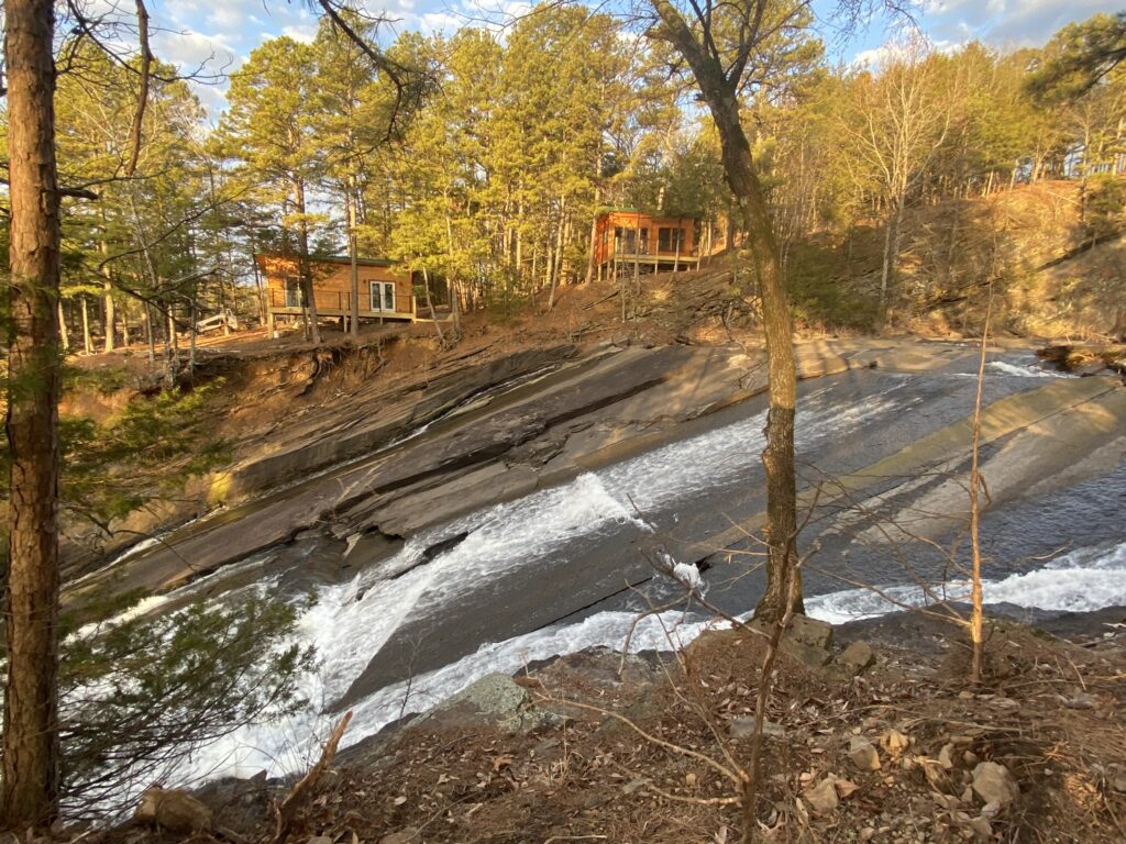 A view of a waterfall from the side of a hill.